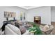 Bright living room with a TV, modern furniture, and access to the outdoors through glass doors at 7017 Via Carmel Way, Orlando, FL 32819