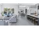 Open-concept living space with pool view, modern seating, and stylish kitchen island at 7017 Via Carmel Way, Orlando, FL 32819