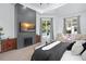 Inviting bedroom with dark fireplace and seamless access to outside lounge and pool at 7017 Via Carmel Way, Orlando, FL 32819