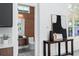 Stylish powder room with wood accent wall and modern fixtures, located off the kitchen at 7017 Via Carmel Way, Orlando, FL 32819