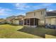 Townhouse backyard with screened patio and grassy area at 1135 Madeira Key Way Way, Orlando, FL 32824