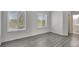 Bedroom with wood-look floors and two windows with blinds at 1135 Madeira Key Way Way, Orlando, FL 32824