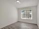 Bright bedroom with gray wood flooring and a large window at 1135 Madeira Key Way Way, Orlando, FL 32824