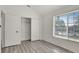 Well-lit bedroom featuring gray flooring and a double door closet at 1135 Madeira Key Way Way, Orlando, FL 32824