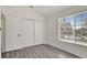 Well-lit bedroom featuring gray flooring and a double door closet at 1135 Madeira Key Way Way, Orlando, FL 32824