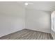 Simple bedroom with wood-look floors and a window with blinds at 1135 Madeira Key Way Way, Orlando, FL 32824