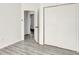 Bright bedroom with grey wood-look flooring and spacious closet at 1135 Madeira Key Way Way, Orlando, FL 32824