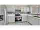 Modern kitchen with gray cabinets, new appliances, and tile backsplash at 1135 Madeira Key Way Way, Orlando, FL 32824