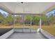Screened porch overlooking backyard with lush greenery at 1135 Madeira Key Way Way, Orlando, FL 32824