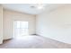 Bright bedroom with balcony access and ceiling fan at 114 Watling Way # 114, Davenport, FL 33897