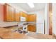 Kitchen with wood cabinets, appliances, and double sink at 114 Watling Way # 114, Davenport, FL 33897