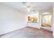 Open living room with kitchen and hallway access at 114 Watling Way # 114, Davenport, FL 33897