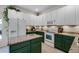 Kitchen with granite countertops, green cabinets, and white appliances at 12411 Mossy Oak Dr, Orlando, FL 32832