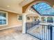 Balcony with iron railings supported by pillars, overlooking the grounds and pool at 125 Stone Hill Dr, Maitland, FL 32751