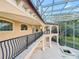 Balcony with iron railing overlooking the grounds featuring an enclosed glass ceiling at 125 Stone Hill Dr, Maitland, FL 32751