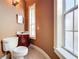 Traditional half bath with a tile floor, dark wood vanity, and a window for natural light at 125 Stone Hill Dr, Maitland, FL 32751