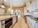 Luxury kitchen showcasing custom cabinets, granite counters, stainless steel appliances, and a center island with sink at 125 Stone Hill Dr, Maitland, FL 32751