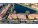 Aerial view of townhomes situated near a beautiful lake with ample parking spaces at 136 Pompano Beach Dr, Kissimmee, FL 34746