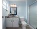 Clean bathroom featuring a vanity with a granite countertop, updated fixtures, and a glass-enclosed shower at 136 Pompano Beach Dr, Kissimmee, FL 34746