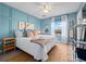 Serene primary bedroom with wood trim accent wall, a ceiling fan, and a view of the outdoors at 136 Pompano Beach Dr, Kissimmee, FL 34746