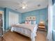 Stylish primary bedroom featuring wood trim accent wall, a ceiling fan, and a neutral color palette at 136 Pompano Beach Dr, Kissimmee, FL 34746