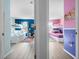 View of two ' bedrooms featuring a blue superhero theme and a pink princess theme at 136 Pompano Beach Dr, Kissimmee, FL 34746
