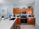 Bright kitchen with stainless steel appliances, light blue walls and stylish countertops at 136 Pompano Beach Dr, Kissimmee, FL 34746