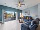 Cozy living room with modern furniture, a ceiling fan, and sliding glass doors to a patio at 136 Pompano Beach Dr, Kissimmee, FL 34746
