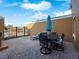 Comfortable patio with outdoor furniture, umbrella, and view of the community at 136 Pompano Beach Dr, Kissimmee, FL 34746