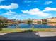 Scenic view of a pond reflecting the surrounding community buildings and trees at 136 Pompano Beach Dr, Kissimmee, FL 34746