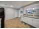 Modern kitchen with white cabinets and granite countertops at 1361 Peters Dr, Leesburg, FL 34748