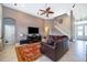 Bright living room featuring neutral walls, tile flooring, high ceilings, and a comfortable leather sofa at 1485 Whitefriar Dr, Ocoee, FL 34761