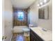 Bathroom with tub, toilet, and dark vanity at 1490 Lake Opal Dr, Apopka, FL 32703