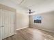 Second bedroom with light walls and wood-look floors at 1490 Lake Opal Dr, Apopka, FL 32703