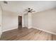 Bright bedroom with ceiling fan and wood-look flooring at 1490 Lake Opal Dr, Apopka, FL 32703