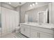 Bathroom boasts double vanity and shower/tub combo at 15107 Lake Claire Overlook Dr, Winter Garden, FL 34787