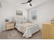 Bright bedroom with a queen-size bed and neutral decor at 15107 Lake Claire Overlook Dr, Winter Garden, FL 34787