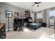 Bedroom with a gaming setup, desk, and built-in shelves at 15107 Lake Claire Overlook Dr, Winter Garden, FL 34787