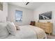 Spacious bedroom with a queen bed, dresser, and a view from the window at 15107 Lake Claire Overlook Dr, Winter Garden, FL 34787