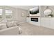 Bonus room features a cozy seating area and a modern fireplace at 15107 Lake Claire Overlook Dr, Winter Garden, FL 34787