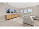 Bright bonus room with large windows, comfortable seating, and built-in shelving at 15107 Lake Claire Overlook Dr, Winter Garden, FL 34787