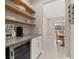 Butlers pantry with wine cooler, coffee bar, and ample shelving at 15107 Lake Claire Overlook Dr, Winter Garden, FL 34787