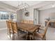 Spacious dining room with a large wooden table and chandelier at 15107 Lake Claire Overlook Dr, Winter Garden, FL 34787