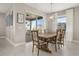 Bright dining room features a rustic wooden table with seating for six at 15107 Lake Claire Overlook Dr, Winter Garden, FL 34787