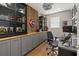 Home office with built-in cabinets and wood wall at 15107 Lake Claire Overlook Dr, Winter Garden, FL 34787