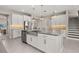 Modern kitchen with large island, stainless steel appliances, and view of dining area at 15107 Lake Claire Overlook Dr, Winter Garden, FL 34787