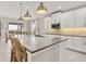 Modern kitchen island with breakfast bar seating and stainless steel appliances at 15107 Lake Claire Overlook Dr, Winter Garden, FL 34787