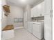 Spacious laundry room, featuring washer, dryer, and ample storage at 15107 Lake Claire Overlook Dr, Winter Garden, FL 34787
