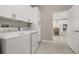 Laundry room with washer, dryer, and a view into the kitchen at 15107 Lake Claire Overlook Dr, Winter Garden, FL 34787