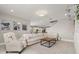 Living room with sectional sofa, coffee table, and built-in shelving unit at 15107 Lake Claire Overlook Dr, Winter Garden, FL 34787